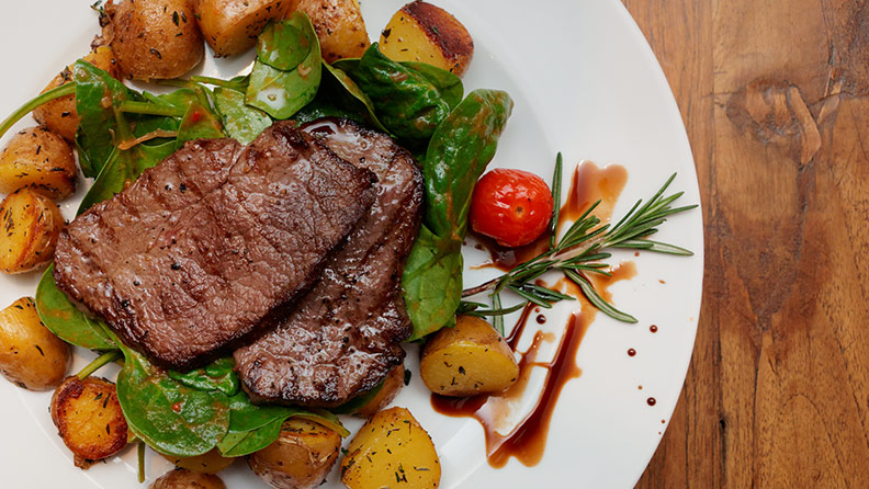 steak and potatoes with spinach and cherry tomatoes